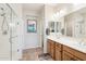 Bright bathroom with glass shower, tile floors, and double sink vanity at 16165 W Vale Dr, Goodyear, AZ 85395