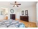 Bedroom showcasing wood floors, ensuite bathroom, ceiling fan, and dual dressers at 16165 W Vale Dr, Goodyear, AZ 85395