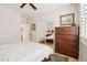 A bedroom featuring hardwood floors, a mirrored closet, neutral walls, ceiling fan, and classic furnishings at 16165 W Vale Dr, Goodyear, AZ 85395