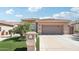 Charming home featuring a two-car garage, desert landscaping, and a welcoming entrance at 16165 W Vale Dr, Goodyear, AZ 85395