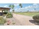 Desert landscaping leading to a fairway view for this home at 16165 W Vale Dr, Goodyear, AZ 85395