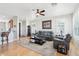 Bright living room with hardwood floors, ceiling fan, and comfortable seating at 16165 W Vale Dr, Goodyear, AZ 85395