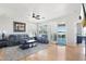 Open living room with ample light, hardwood floors, and patio access at 16165 W Vale Dr, Goodyear, AZ 85395