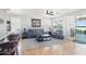 Bright and airy living room with wood floors, ceiling fan and patio views at 16165 W Vale Dr, Goodyear, AZ 85395