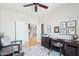 This office space features a ceiling fan, hardwood floors, neutral walls, and a view to the kitchen at 16165 W Vale Dr, Goodyear, AZ 85395