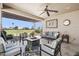 Covered patio with ceiling fan, seating, and views of a lush green golf course at 16165 W Vale Dr, Goodyear, AZ 85395
