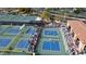 Aerial view of the community pickleball courts, showcasing a vibrant sporting atmosphere and ample seating for spectators at 16165 W Vale Dr, Goodyear, AZ 85395