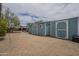 Large backyard with multiple storage sheds, desert landscaping, and connection to the patio area at 1637 W University Dr, Mesa, AZ 85201