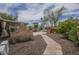 Backyard includes a fireplace, shed, hot tub, and a stone pathway, offering diverse outdoor living and relaxation options at 1637 W University Dr, Mesa, AZ 85201
