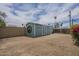 Spacious backyard with a shed, landscaping, and sunny sky at 1637 W University Dr, Mesa, AZ 85201