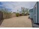View of the backyard area showing desert landscaping and storage area with colorful flowering bushes at 1637 W University Dr, Mesa, AZ 85201
