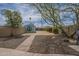 A view of the backyard with a small shed, gravel and block fence at 1637 W University Dr, Mesa, AZ 85201