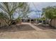 Backyard view with desert landscaping, seating area, and hot tub at 1637 W University Dr, Mesa, AZ 85201