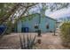 Backyard of a home with a view of an agave plant, utility services, and a home painted blue with a chimney at 1637 W University Dr, Mesa, AZ 85201
