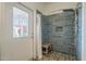 Well-lit bathroom featuring a tiled walk-in shower with a wood bench at 1637 W University Dr, Mesa, AZ 85201