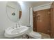 Well-lit bathroom featuring a round mirror above the sink and tiled walk-in shower at 1637 W University Dr, Mesa, AZ 85201