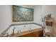 Luxurious soaking tub with tile surround and decorative accents at 1637 W University Dr, Mesa, AZ 85201
