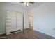 Bright bedroom with a ceiling fan, wood floors, and fold out bed at 1637 W University Dr, Mesa, AZ 85201