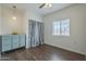 Well-lit bedroom with hardwood floors, and a vintage dresser at 1637 W University Dr, Mesa, AZ 85201