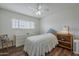 Sunny bedroom featuring a ceiling fan, wood floors, and ample natural light at 1637 W University Dr, Mesa, AZ 85201