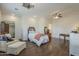 Bright bedroom with a wooden-framed bed and a comfortable seating area at 1637 W University Dr, Mesa, AZ 85201