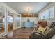 Cozy bedroom view, hardwood floors, vintage dresser, brick archway to bed, chandelier, and desk at 1637 W University Dr, Mesa, AZ 85201