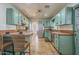 Spacious eat-in kitchen features unique turquoise cabinets and tile countertops at 1637 W University Dr, Mesa, AZ 85201