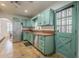Functional kitchen with stainless appliances, tile floors, and exterior access at 1637 W University Dr, Mesa, AZ 85201