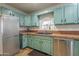 Light-filled kitchen featuring stainless appliances, tile backsplash, and custom cabinetry at 1637 W University Dr, Mesa, AZ 85201
