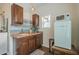 Charming kitchenette with wooden cabinets, vintage-style refrigerator, and tiled backsplash at 1637 W University Dr, Mesa, AZ 85201