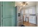 Combined pantry and laundry area with stainless refrigerator and white appliances at 1637 W University Dr, Mesa, AZ 85201