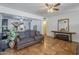Living room showcasing ceiling fans, tile flooring, front entry, and decorative furnishings at 1637 W University Dr, Mesa, AZ 85201
