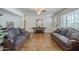 Cozy living room with tile floors, twin sofas, front door view, and decorative furnishings at 1637 W University Dr, Mesa, AZ 85201