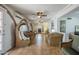 Bright living room with arched windows, terracotta tile, and comfortable wicker seating with ceiling fans at 1637 W University Dr, Mesa, AZ 85201