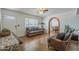 Comfortable living room with tile floors, an archway, and traditional decor, perfect for cozy gatherings and everyday living at 1637 W University Dr, Mesa, AZ 85201