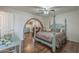Charming bedroom showcasing four poster bed, brick arch, and vintage desk with hardwood floors at 1637 W University Dr, Mesa, AZ 85201