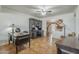 Office with dark wood desk, tile floors, and a view of the home's interior archway at 1637 W University Dr, Mesa, AZ 85201