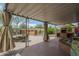 Spacious patio area with a hot tub, built-in BBQ, and comfortable seating under a covered awning, perfect for entertaining at 1637 W University Dr, Mesa, AZ 85201