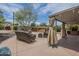 This beautiful outdoor patio is complete with a large cushioned sofa, hot tub, and covered grilling area at 1637 W University Dr, Mesa, AZ 85201