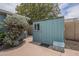 View of a painted shed with a side door, small window, and storage box in the backyard at 1637 W University Dr, Mesa, AZ 85201