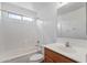 Well-lit bathroom with a combined tub and shower, plus a wood vanity at 1669 E Santa Fiore St, San Tan Valley, AZ 85140