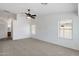 Spacious carpeted bedroom with fan and multiple windows at 1669 E Santa Fiore St, San Tan Valley, AZ 85140
