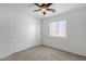 Cozy bedroom with neutral carpet, ceiling fan, and natural light from a window at 1669 E Santa Fiore St, San Tan Valley, AZ 85140