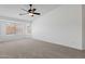 Spacious carpeted bedroom with fan and large windows at 1669 E Santa Fiore St, San Tan Valley, AZ 85140