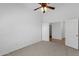 Neutral bedroom with a ceiling fan and an open door to the hallway at 1669 E Santa Fiore St, San Tan Valley, AZ 85140
