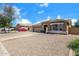 Single-story home with a gravel yard, stone accents, and a two-car garage at 1669 E Santa Fiore St, San Tan Valley, AZ 85140