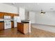 Open-concept kitchen with wooden cabinets, white appliances, and a large island at 1669 E Santa Fiore St, San Tan Valley, AZ 85140