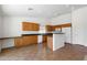 Open-concept kitchen with tile floors, wooden cabinets, and neutral walls at 1669 E Santa Fiore St, San Tan Valley, AZ 85140