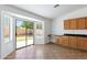 Bright eat-in kitchen area with earth tone floors, built-in desk area and access to backyard at 1669 E Santa Fiore St, San Tan Valley, AZ 85140