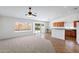 Open floor plan with tiled eat-in kitchen and carpeted living room at 1669 E Santa Fiore St, San Tan Valley, AZ 85140